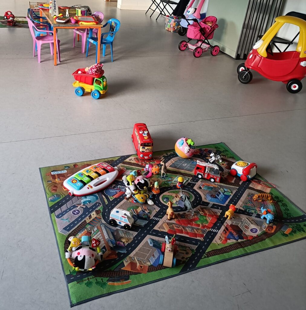 Children’s play area with toys and play mat in a community centre