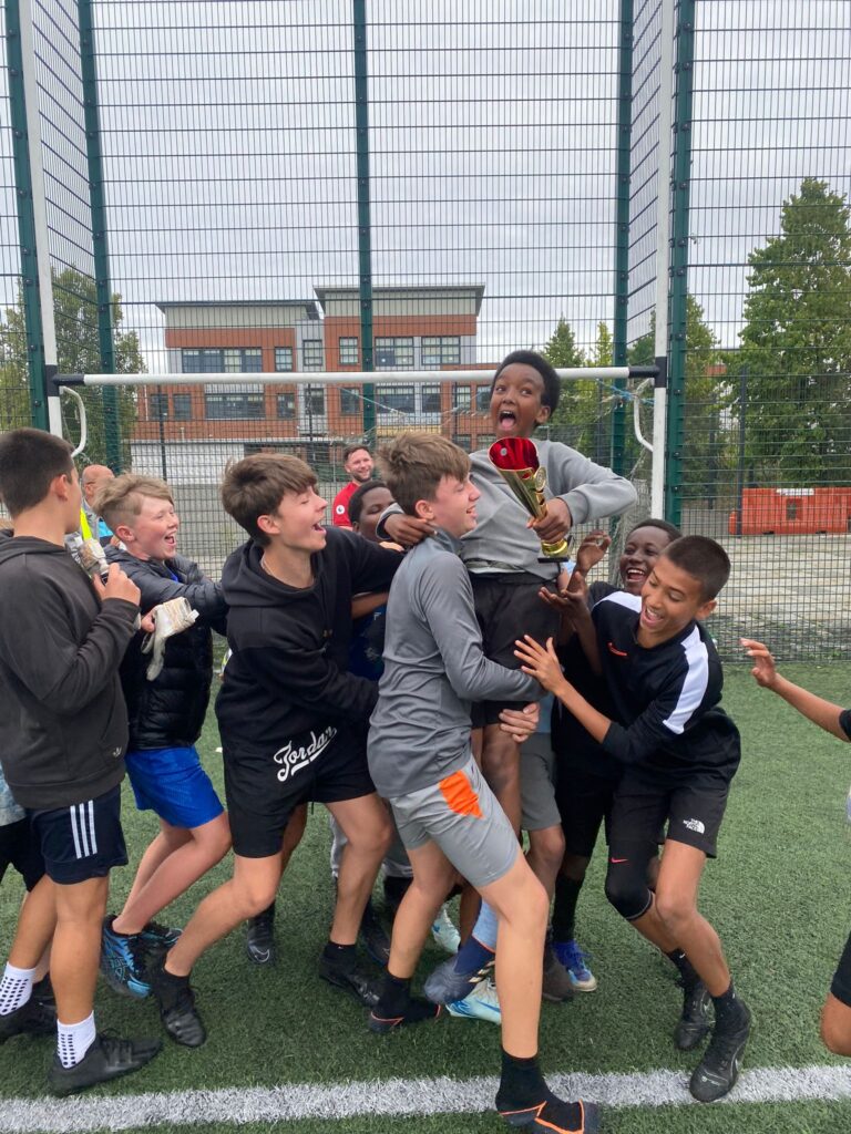 Children celebrating after a football match 2024